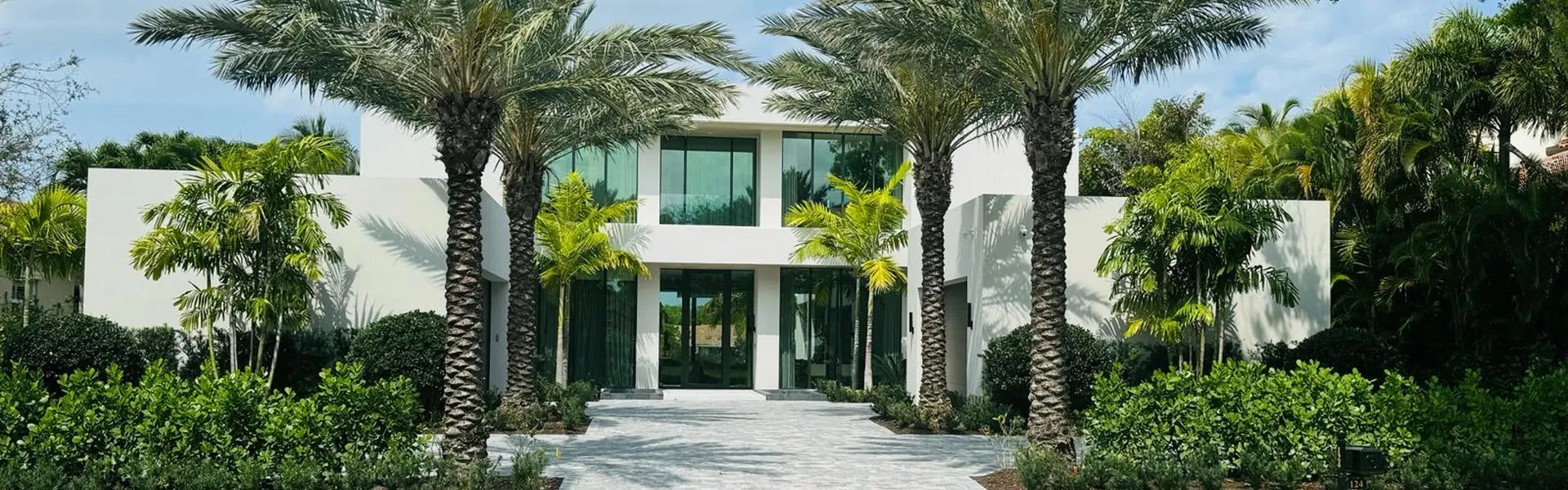 Modern stucco home with tropical landscaping in Florida